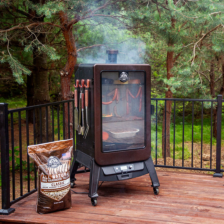 Pit Boss Copperhead 7 Series Vertical Wood Pellet Smoker, Mahogany Color. Smoking meats and foods in smoker on back patio in woods